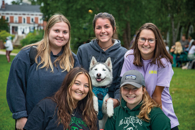 group of students with a dog